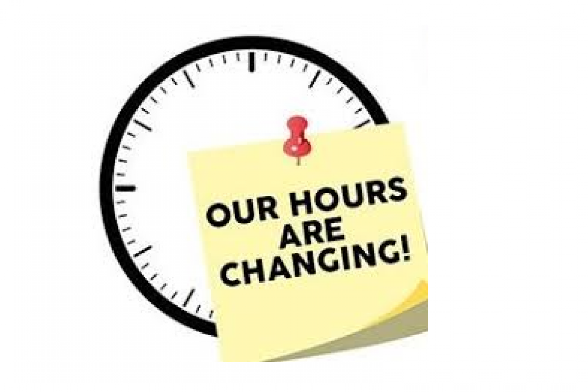 Image of a clock with a sticky note saying our hours are changing